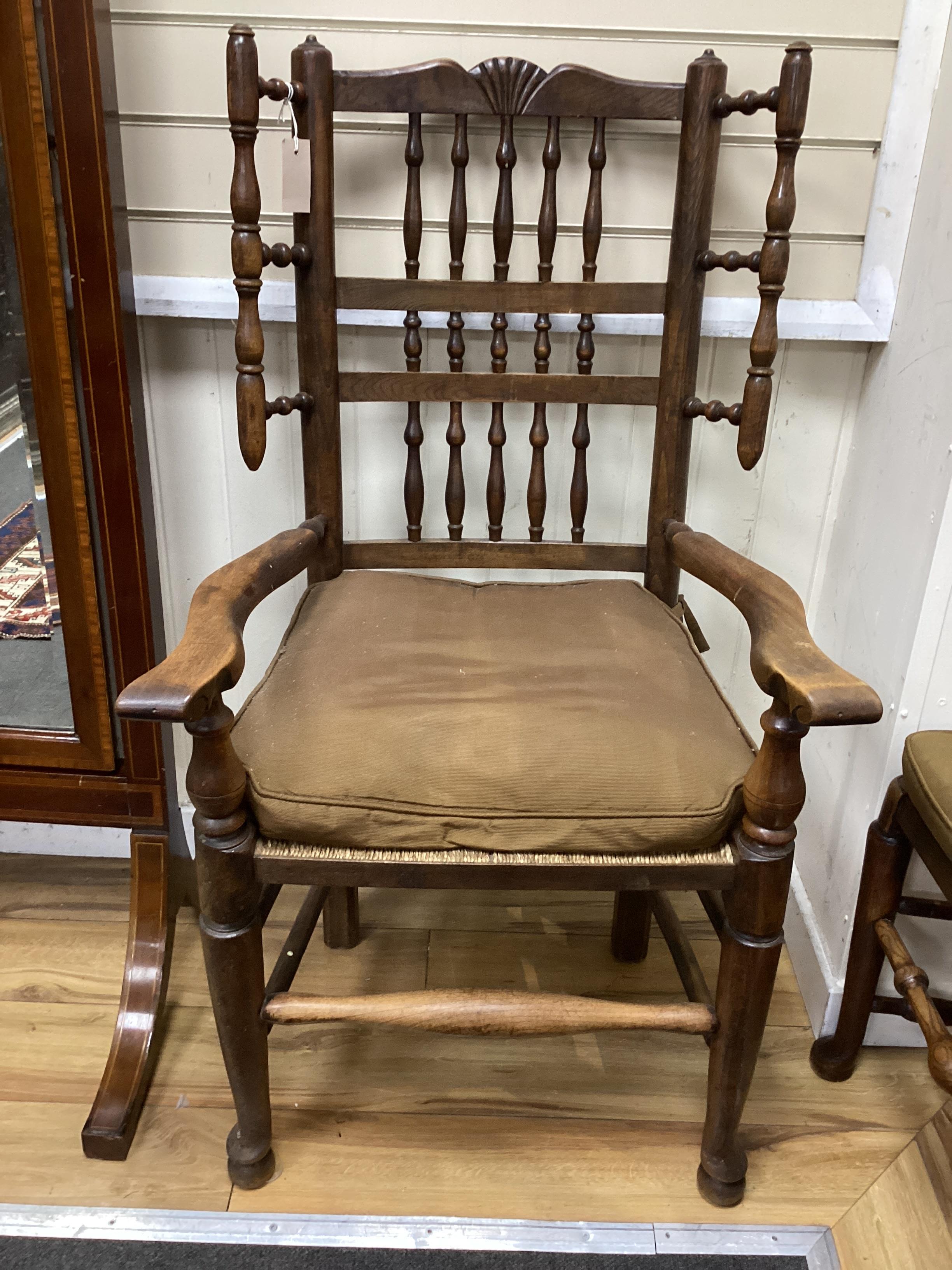 A harlequin set of twelve 19th century Lancashire ash elm and beech rush seat spindle back chairs with loose cushion squab seats, two with arms